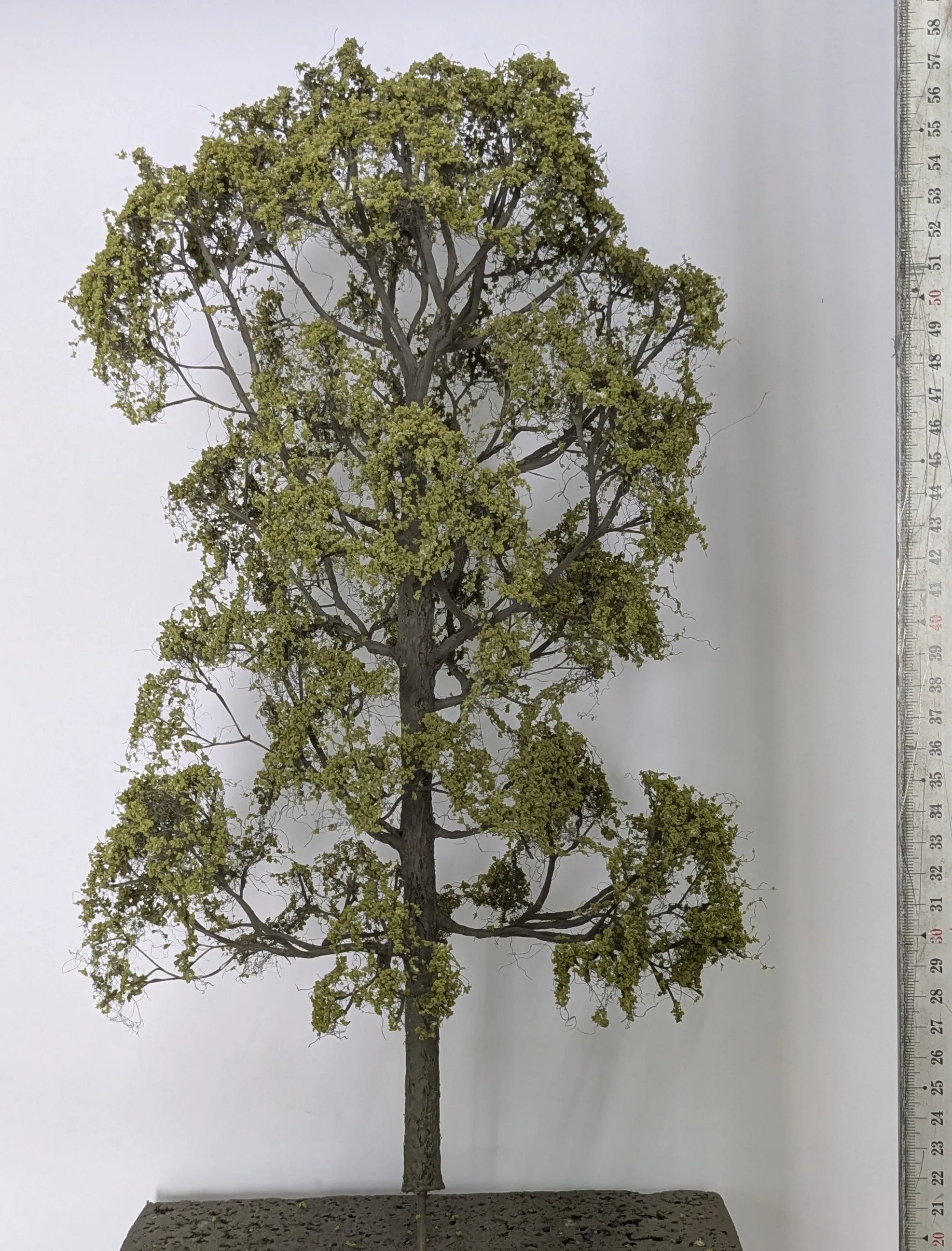 A finished tree beside a ruler